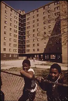 Two black children in front of a residential building at the Stateway Gardens housing project